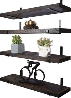 three wooden shelves with metal brackets and two potted plants on one shelf next to a bicycle