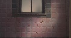 some bugs are crawling around the corner of a window in a pink bricked wall