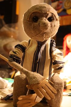 a stuffed animal holding a wooden stick on top of a facebook page with the caption deadpott die wei der puppen