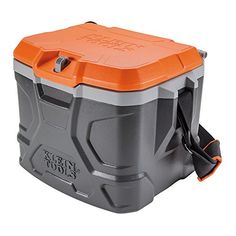 an orange and gray cooler on a black background with the lid closed to show it's inner compartment