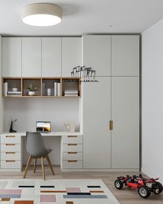 a room with a desk, chair and toy car on the floor in front of it