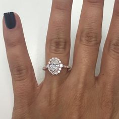 a woman's hand with a diamond ring on it