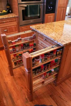 an open cabinet in the middle of a kitchen