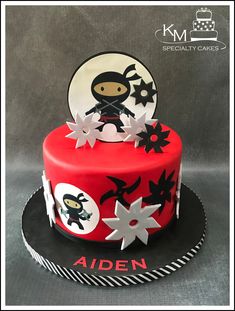 a red cake with white and black decorations