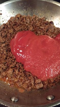 meat sauce being stirred in a pan on the stove