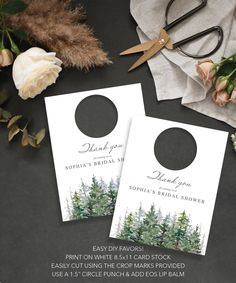 two wedding door hangers with pine trees on them next to some flowers and scissors