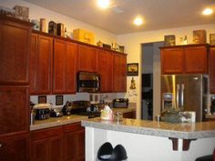 a kitchen with wooden cabinets and granite counter tops