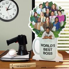 a coffee mug with the faces of actors on it next to a clock and other items