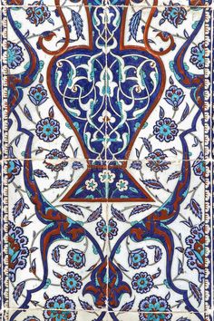 an intricately designed rug with blue, red and white designs on the side of it