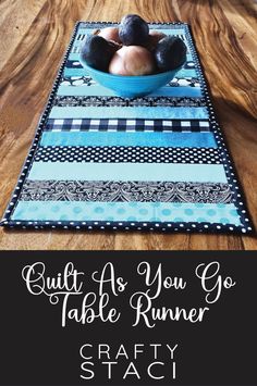 a table runner that has some balls in it and the words crafty staci on