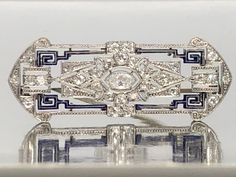 An Antique Elegant and Gorgeous 18K Gold and Platinum Enameled and Diamond Brooch, With a Hallmark of "14601"Total Weight is 7.50 grams. The Center Diamond is Marquise Cut, Measuring 5.75x3mm, and Weighing 0.24ct F/VS2. Surrounded by 24 Single Cut Diamonds, Measuring 1.80 mm – 2mm, Weighing a total of 0.66ctwH/VS2. Silver Elegant Enamel Pin For Formal Use, Silver Elegant Enamel Pin For Formal Events, Elegant Silver Enamel Pin For Formal Occasions, White Art Deco Brooches For Formal Occasions, Edwardian Jewelry, Diamond Brooch, Amethyst Jewelry, Marquise Cut, Antique Jewelry