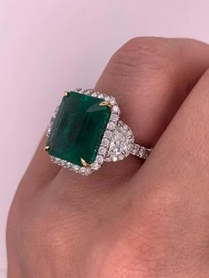 For Sale on 1stDibs - GIA Certified Green Emerald and Diamond Ring, Features 14.13 Carats Emerald Cut Green Emerald, Certified by GIA, set with two half moons, surrounded by Luxury Gia Certified Emerald Diamond Ring, Luxury Emerald Ring With Cushion Cut Center Stone, Gia Certified Diamond Emerald Ring For Formal Occasions, Gia Certified Emerald Diamond Ring For Formal Occasions, Luxury Cushion Cut Emerald Ring With Center Stone, Formal Gia Certified Diamond Emerald Ring, Luxury Green Diamond Ring With Round Cut, Luxury Green Round Cut Diamond Ring, Gia Certified Dazzling Emerald Ring With Diamond