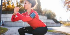 a woman squatting down while listening to music