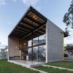 the modern house is made out of concrete and glass