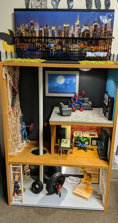 a doll house with toys and furniture in it's display case on the floor