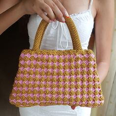 This is an elegant top handle crochet bag suitable for both everyday and evening use. Made from shiny polyester macramé yarn, it has a unique shiny look to it.  It is lined with a shiny satin-like fabric and has an inside pocket. Comes in two different colors (Gold - Pink & Gold - Light Yellow). Height: 18cm (7") Length: 26cm (10.2") Width: 8cm (3.1") Crochet Handbag, Fashion Crochet, Gold Handbags, Macrame Cord, Gold Light, Chic Handbags, Crochet Handbags, Handle Bag, Light Yellow