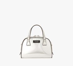 Taking inspiration from the '90s (when the original Sam bag debuted!) our Sam mini duffle bag comes with an optional crossbody strap. It's done in metallic smooth leather for a sleek finish. | Kate Spade Sam Icon Metallic Mini Duffle Bag, Silver Silver Glossy Finish Bags, Kate Spade Luxury Silver Bag, Luxury Silver Kate Spade Bag, Kate Spade Silver Bag For Everyday Use, Kate Spade Silver Bag For Everyday, Kate Spade Silver Everyday Bag, Silver Kate Spade Bag For Everyday, Mini Duffle Bag, Bag Silver