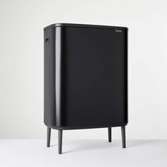 a black cabinet sitting on top of a white floor