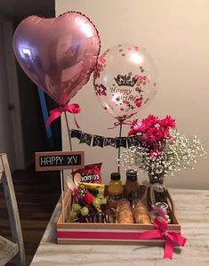 a table with some balloons and food on it