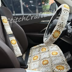 the interior of a car with crocheted sunflowers on the seat covers