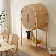 a dining room table with chairs and a shelf