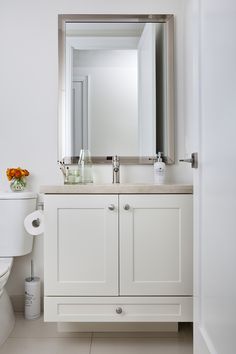 a bathroom with a sink, toilet and mirror