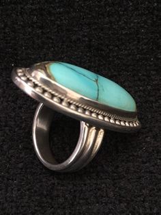 "Ring ~ Artist: Teresa Bradford-Cole Natural Stone Oval Turquoise Heavy Gauge Sterling Silver Be bold in style with this stunning long turquoise stone It features a long oval natural stone Many tribes considered turquoise to be a stone of the sky and wearing items of turquoise jewelry provided protection, good health, and long life. Size: 8 Length: 1 3/4\" Width:3/4 You deserve to know about my fabulous Treasure chest Modern Tribal Jewelry, Statement Piece Jewelry, Art to Wear Jewelry, Fantastic Elegant Green Turquoise Ring, Oval Multi-stone Turquoise Ring, Oval Turquoise Multi-stone Ring, Turquoise Multi-stone Round Gemstones, Turquoise Multi-stone Gemstones, Luxury Turquoise Cabochon Ring, Oval Turquoise Ring With Stones, Elegant Turquoise Ring Collectible, Luxury Silver Ring With Turquoise Oval Gemstone