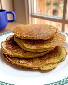 a stack of pancakes sitting on top of a white plate