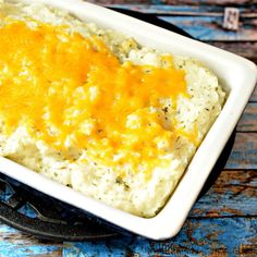 a casserole dish with mashed potatoes and cheese