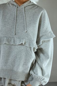 Frilled Out From Under hoodie sweatshirt in a slouchy, oversized fit. Designed in a soft, vintage-washed knit featuring a classic hood with string details, long sleeves and front kanga-pocket all trimmed with ruffles for femme flair. Find it only at Urban Outfitters. Features Out From Under Fade Away ruffled hoodie sweatshirt Oversized hoodie sweatshirt Soft vintage washed knit Crew neckline with hood & string details Ruffled drop shoulders and long sleeves Ruffle trim around the waist Front kanga pocket Ruffle detail across the back Slouchy, oversized fit Tunic length Easy pull-over style UO exclusive Content + Care 38% Polyester, 38% cotton, 24% viscose Machine wash Imported Size + Fit Model in Charcoal is 5’8" and wearing size Small Measurements taken from size Small Chest: 24.5" Length Spring Cotton Sweatshirt With Ruffles, Spring Cotton Ruffle Sweatshirt, Spring Cotton Ruffled Sweatshirt, Spring Hooded Washed Top, Spring Washed Hooded Top, Casual Long Sleeve Ruffled Sweatshirt, Casual Long Sleeve Ruffle Sweatshirt, Casual Ruffled Crew Neck Sweatshirt, Casual Ruffled Sweatshirt For Fall