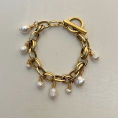 A bracelet inspired by an Italian summer. Sitting at 7. 5" with a unique 12k antiqued gold plated brass multi-ring chain. This bracelet has an organically shaped 12k antiqued gold plated pewter toggle clasp and hand wire-wrapped freshwater pearl accents. Avoid contact with water, perfumes and lotions. Multi Ring, Bracelet Inspired, Italian Summer, A Bracelet, Unique Antiques, Bari, Toggle Clasp, Chain Ring, Gold Pearl