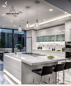 a modern kitchen with an island and bar stools