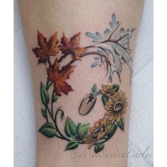 a woman's leg with flowers and leaves painted on the bottom part of it