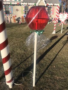 candy canes are wrapped in cellophane and tied to poles