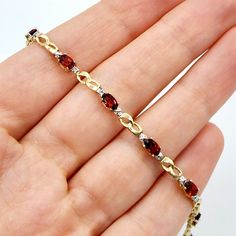 10K Yellow Gold Bracelet Ten Genuine Garnet 2.3cts Size of each stone: 5x3mm With 2 Diamonds 0.02cts Weight: 4 gm Length: 7 inches Made in Canada Garnet is the birthstone for January and known as the stone of regeneration and passion. Comes in a Beautiful Gift Box / Perfect for Gifting This item is available in different gemstone selections. Please feel free to message me if you need any further information or if you have specific preferences regarding the gemstone for your order. Garnet And Gold, Garnet Bracelet, Red Bracelets, Garnet Jewelry, Wedding Jewelry Bracelets, January Birthstone, White Gold Diamond Rings, Dainty Bracelets, Yellow Gold Bracelet