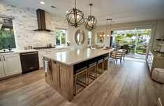 a large kitchen with an island in the middle and lots of counter space on one side