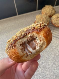 1 s’mores doughnut with a bite taken out of it, with nutella and marshmallow fluff oozing out of the centre S’mores Doughnut, Filled Doughnut Recipe, Gourmet Donuts Ideas, Stuffed Doughnut, Smoothie Packaging, Donuts Shop, Dessert Package, Brioche Donuts