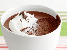 a white bowl filled with chocolate pudding and whipped cream