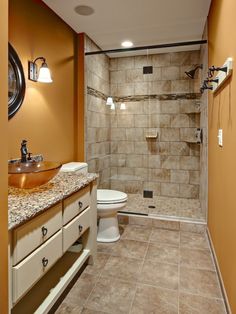 a bathroom with a sink, toilet and shower