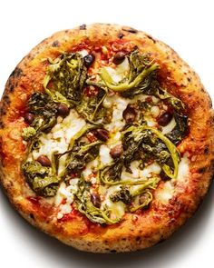 a pizza with broccoli and other toppings on it