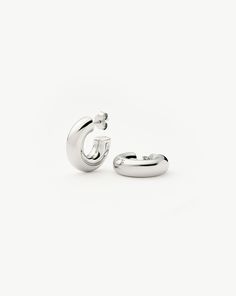 Chubby Small Hoop Earrings | Sterling Silver. A Lightweight Version of Our Everyday Icon. Bold, Chunky, and Versatile these Small Hoops are a Standout Style You Can Easily Wear Day to Night. Create Contrast in Your Ear Stack by Teaming with Delicate Huggies or Mixing Metals. Also Available in Mini, Medium and Large. Metal: Rhodium Plated on Recycled 925 Sterling Silver Hoop Thickness: 6mm Hoop Diameter: 20mm Weight: 5. 5g Product Code: Ch-S-E8-Ns Mixing Metals, Diamond Initial Necklace, Trending Bracelets, Coin Pendant Necklace, Small Hoop Earrings, Earring Trends, Ear Stack, Engraved Jewelry, Engraved Necklace