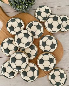 black and white soccer ball cookies on a wooden board