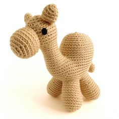 a crocheted giraffe stuffed animal on a white background