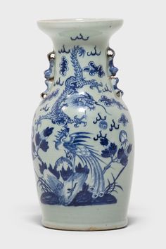 a blue and white vase sitting on top of a table