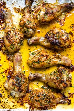 grilled chicken wings with herbs and seasoning on a baking sheet, ready to be cooked