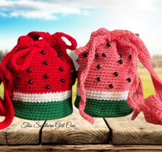 three crocheted watermelon bags sitting on a wooden table next to each other