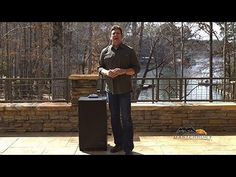 a man standing next to two black trash cans