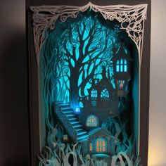 a paper cut out of a house in the woods