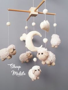 there is a crocheted mobile with sheep on it