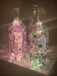 two glass bottles with different colored buttons on them